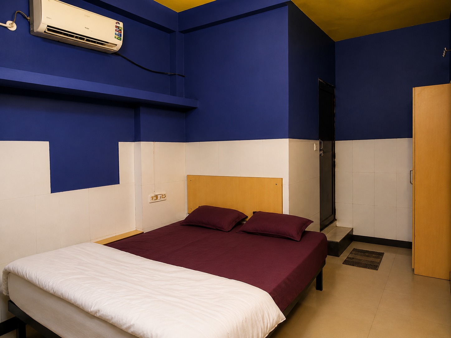 Classic room with blue walls and a maroon bedspread